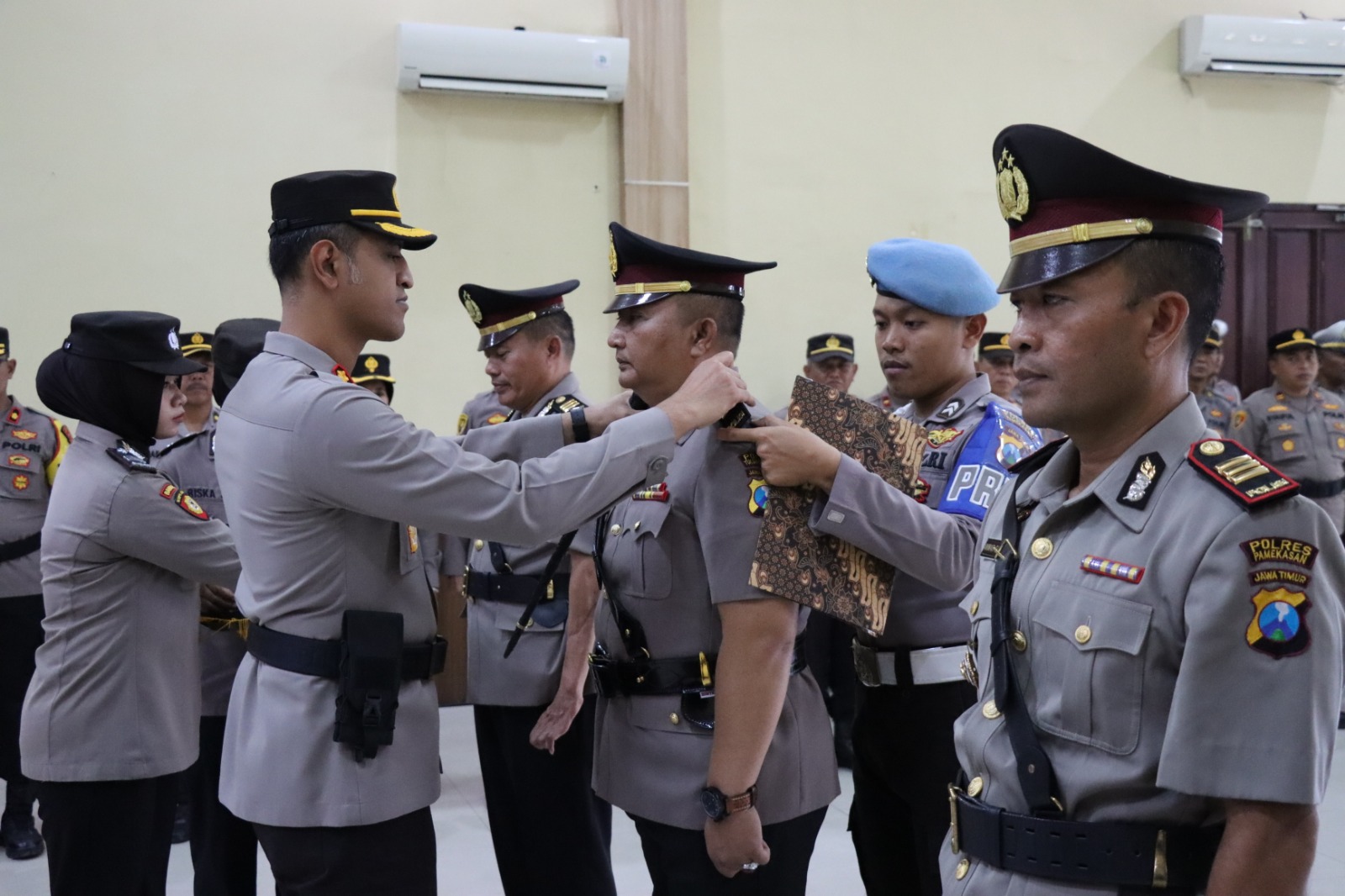 SERTIJAB: Kapolres Pamekasan AKBP Satria Permana memasang pangkat di bahu Kasatlantas Polres Pamekasan AKP L Rahmad Budiarto, Sabtu (28/10).