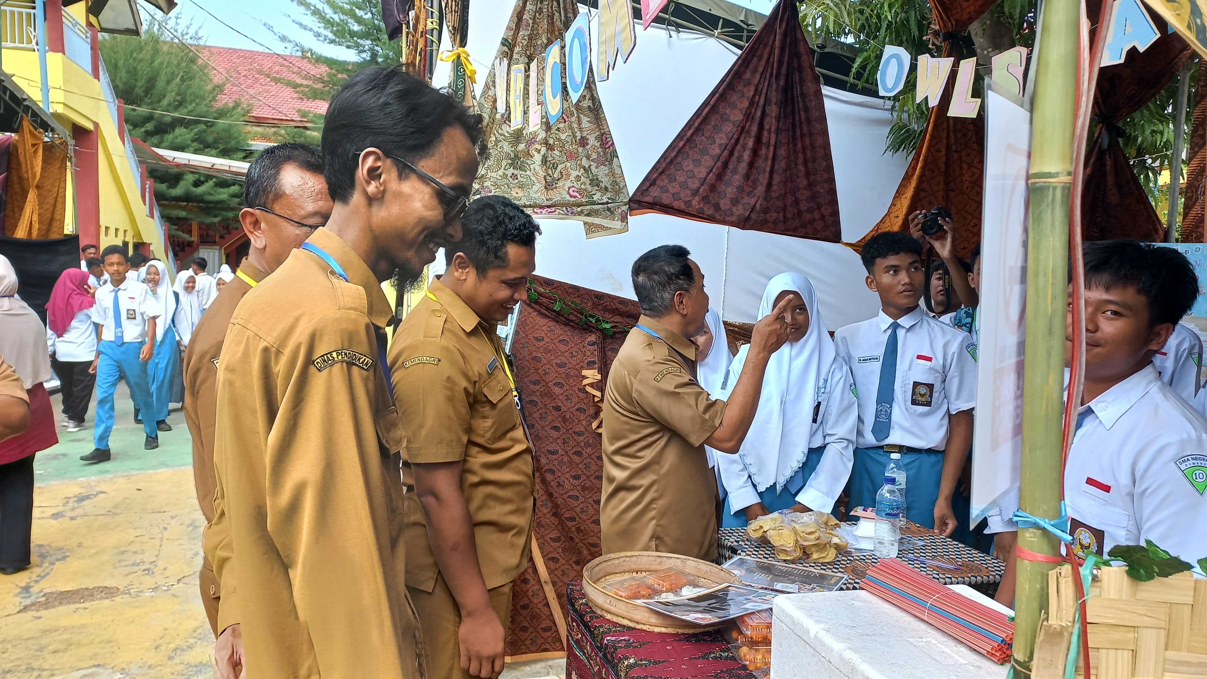 SEMARAK: Kepala SMA Negeri 2 Sumenep Drs. Sukarman meninjau stand bazar PKWU para siswa di sekolahnya pada Selasa (19/12).