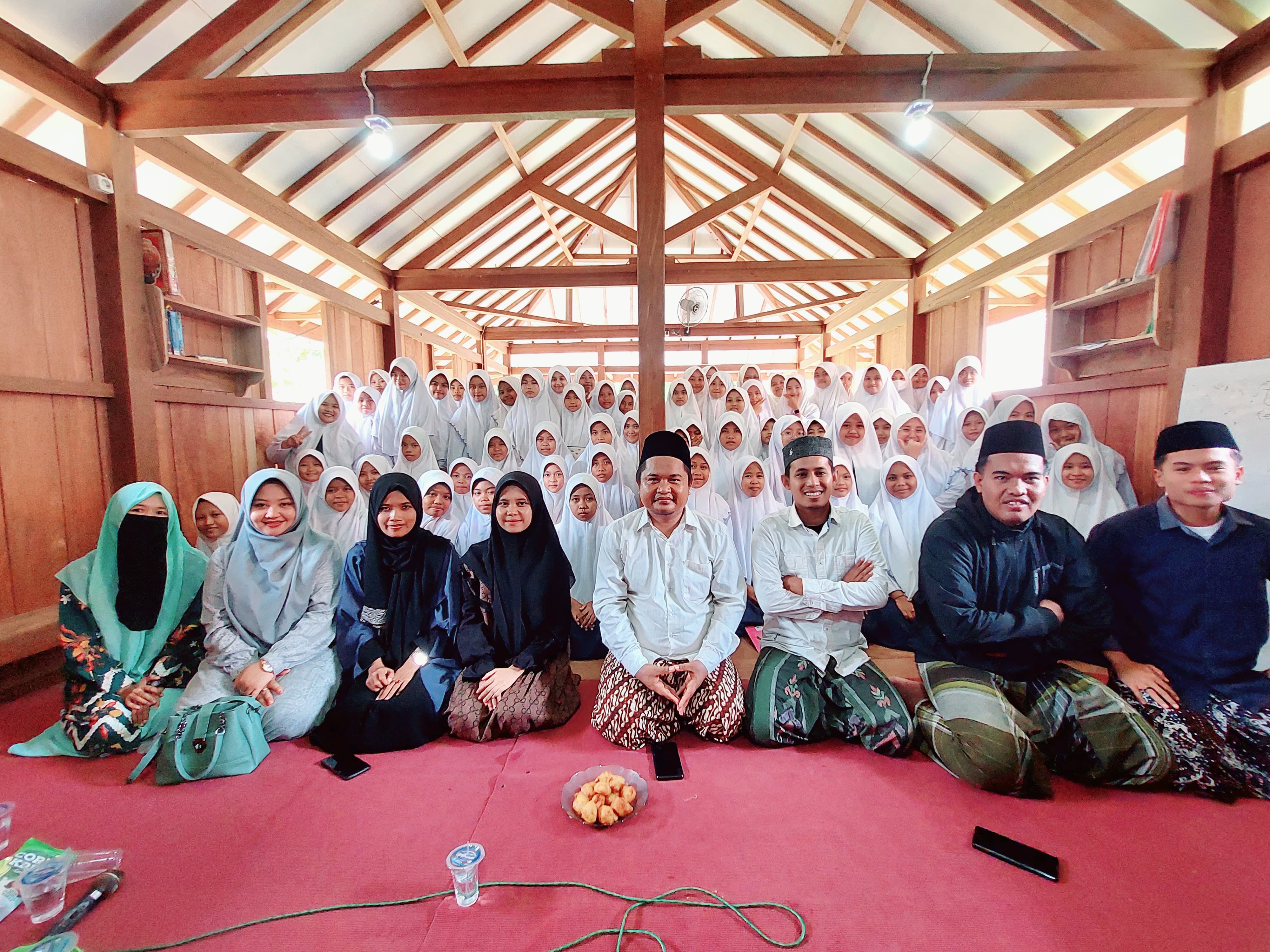 SEMANGAT: Ketua PGMNI Jatim Moh. Ali Muhsin bersama relawan dan pengurus PGMNI Jatim foto bersama siswa MTs Miftahul Ulum, Tambaagung Area, Ambunten, Sumenep. (KHOBIR FOR RADARMADURA.ID)