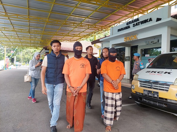 PASRAH: Dua tersangka pembunuhan di Bumi Anyar, Tanjungbumi, Bangkalan, digiring petugas menuju lokasi konferensi pers Minggu (14/1). (ZEINAL ABIDIN/JPRM)