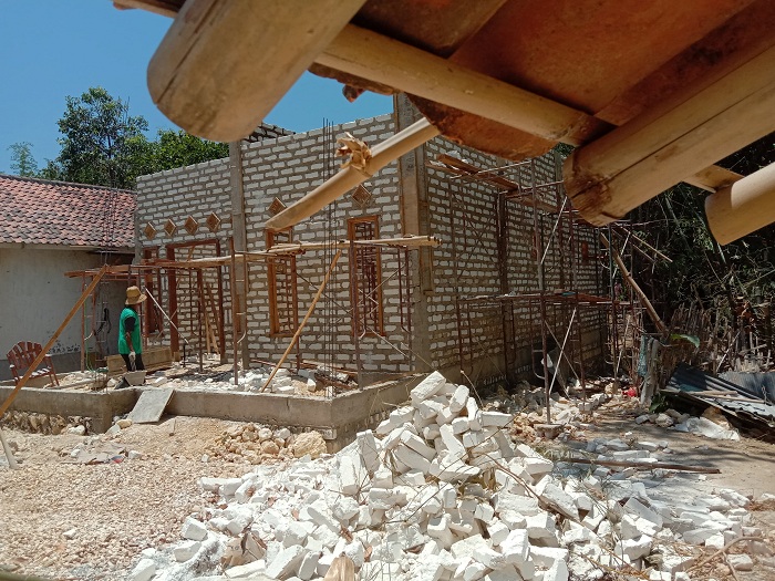 PROSES: Dua tukang berada di depan rumah program RTLH yang akan dibangun, 16 Oktober 2023. (LAILIYATUN NURIYAH/JPRM)