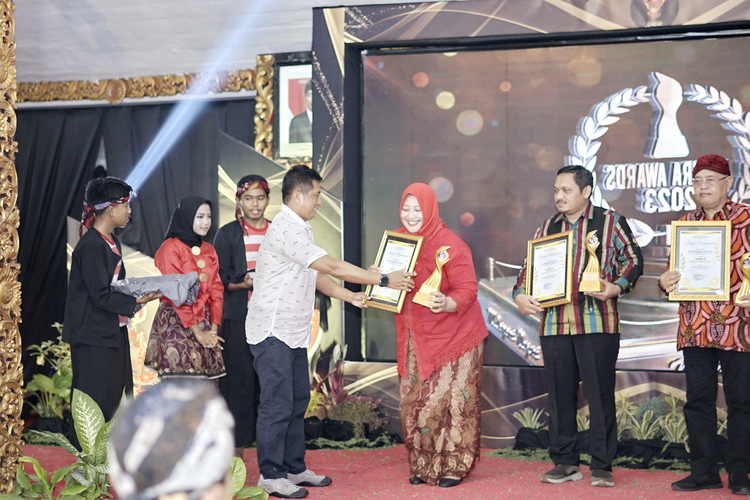 TERBAIK: Tokoh Penggiat Pendidikan Terpopuler Madura Awards 2023 Pinky Hidayati menerima trofi dan piagam penghargaan yang diserahkan oleh Ketua Said Abdullah Institut Januar Herwanto.