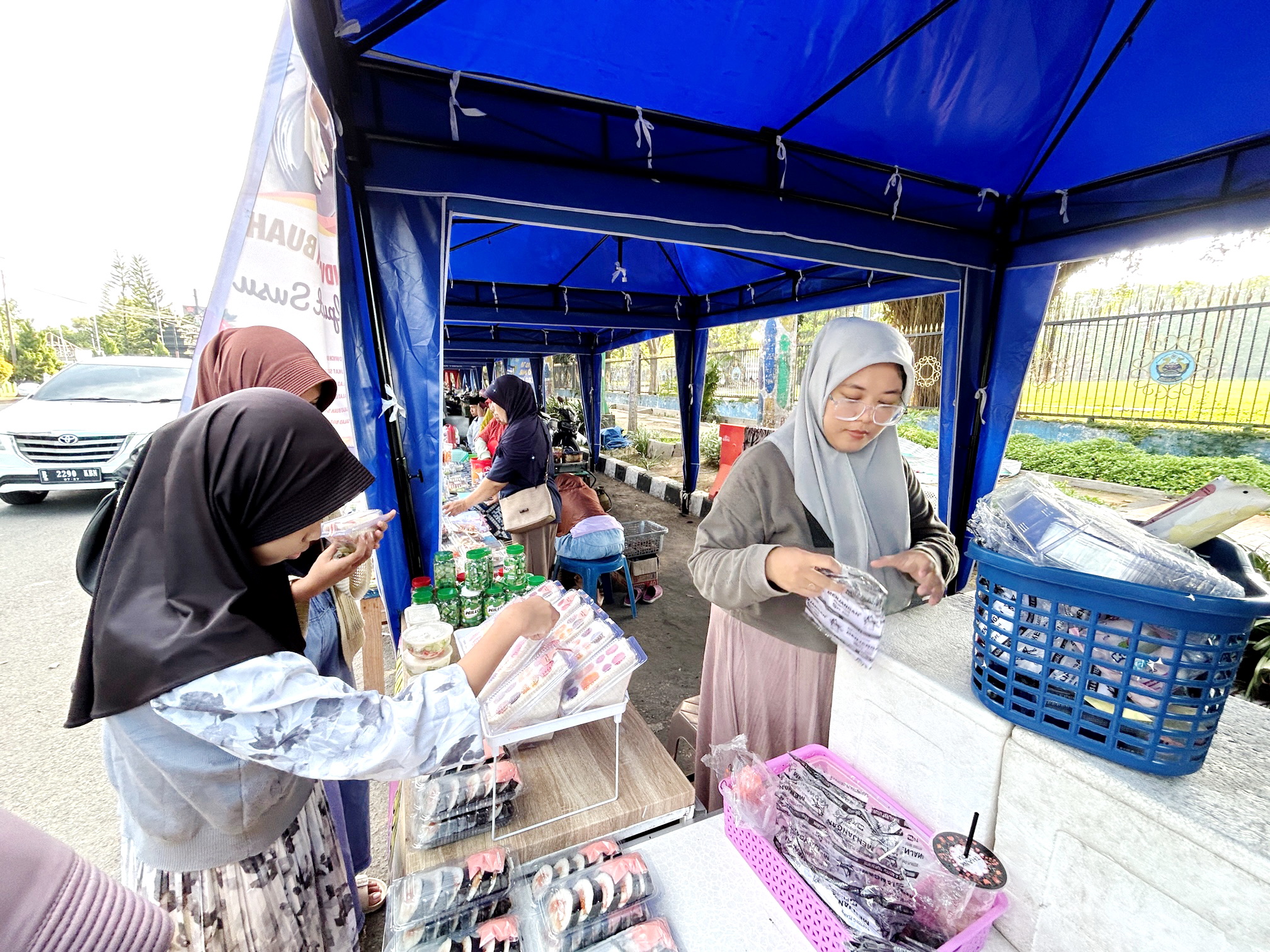 MAKANAN KEKINIAN: Siti Aminatus Syafa sedang melayani pembeli di Bazar Takjil Ramadan, Jalan Letnan Abdullah, Bangkalan, Sabtu (24/3). (VIVIN AGUSTIN HARTONO/JPRM)