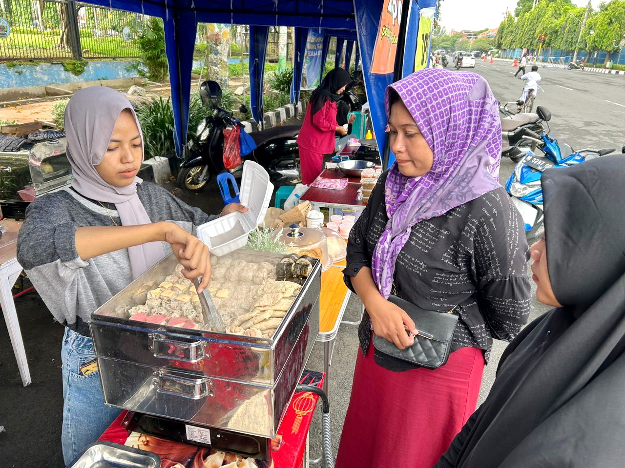 KHAS JEPANG: Diah Fitriana Suryani melayani pembeli di Bazar Takjil Ramadan, Jalan Letnan Abdullah, Kelurahan Kraton, Bangkalan, Senin (1/4). (VIVIN AGUSTIN HARTONO/JPRM)