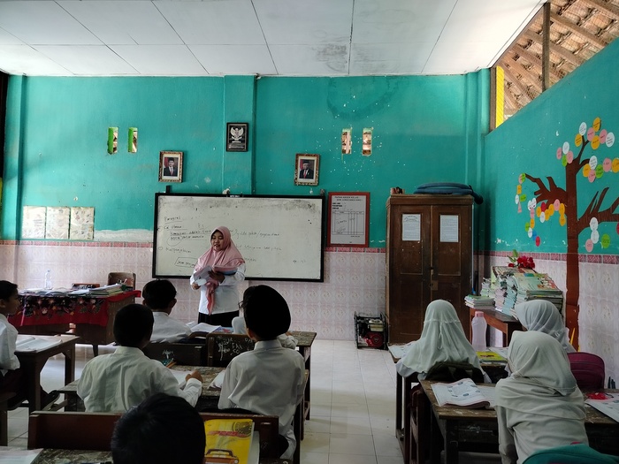MENDIDIK: Seorang guru honorer di SDN Jungcangcang 1 Pamekasan saat memberikan materi kepada anak didiknya, Senin (20/5). (LAILIYATUN NURIYAH/JPRM)