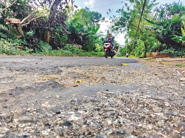 RUSAK: Pengendara sepeda motor melintas di jalan Desa Jaddih, Kecamatan Socah, Bangkalan, Minggu (9/6). (VIVIN AGUSTIN HARTONO/JPRM)