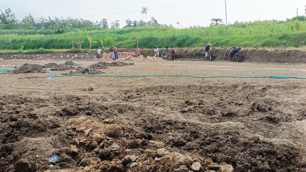 MEMBANGUN DESA: Pekerja sedang membangun drainase di Dusun Berumbung, Desa Tobai Tengah, Kecamatan Sokobanah, Sampang, beberapa waktu lalu.