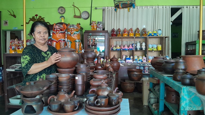 KERAJINAN: Pedagang gerabah Busadi membersihkan barang daganganya di Jalan Mayjen Sungkono, Kelurahan Kraton, Bangkalan, Minggu (30/6). (M. KHOLIL RAMLI/JPRM)