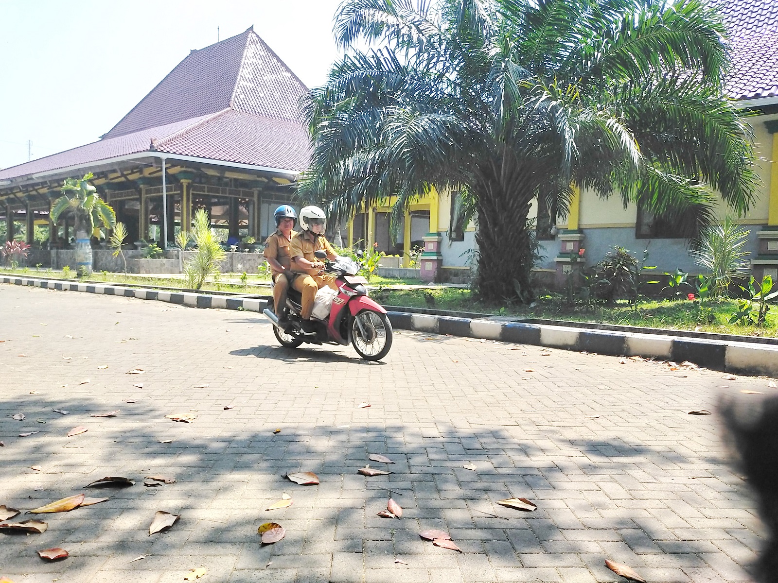 ABDI NEGARA: Aparatur sipil negara melintas di halaman Pemkab Bangkalan, Senin (12/8).