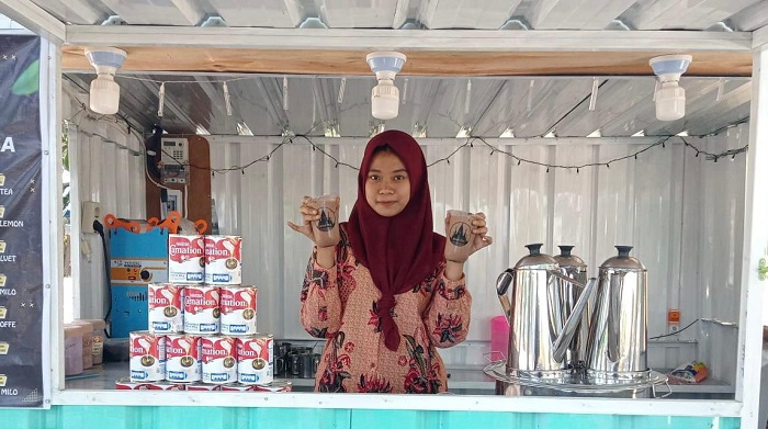 SEGAR: Ela menunjukkan minuman thai tea di Desa Sendang Dajah, Kecamatan Labang, Bangkalan, Sabtu (24/8). (AYU LATIFAH/JPRM)