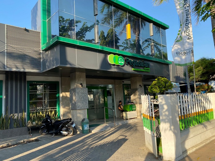 JAM PULANG: Penjaga berada di depan pintu masuk kantor Pegadaian Pamekasan Selasa (29/10). (FAHMI JALIL/JPRM)
