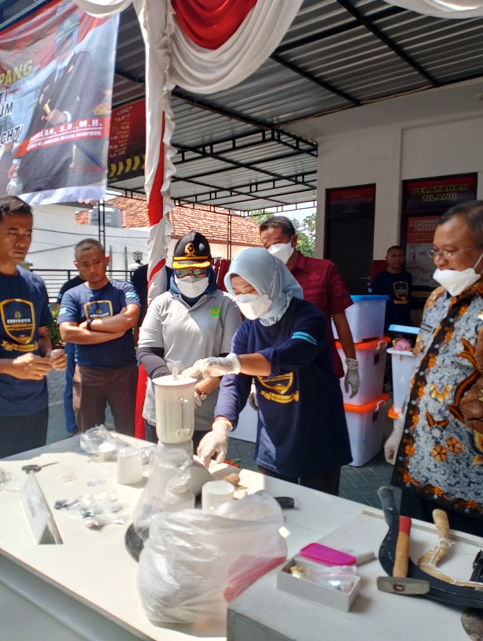 DIMUSNAHKAN: Kajari Sampang Fadilah Helmi (kerudung biru muda) menunjukkan senjata api dan senjata tajam yang akan dimusnahkan di halaman kantor, Jumat (15/11). (UBAIDILLAHIR RA&rsquo;IE/JPRM)