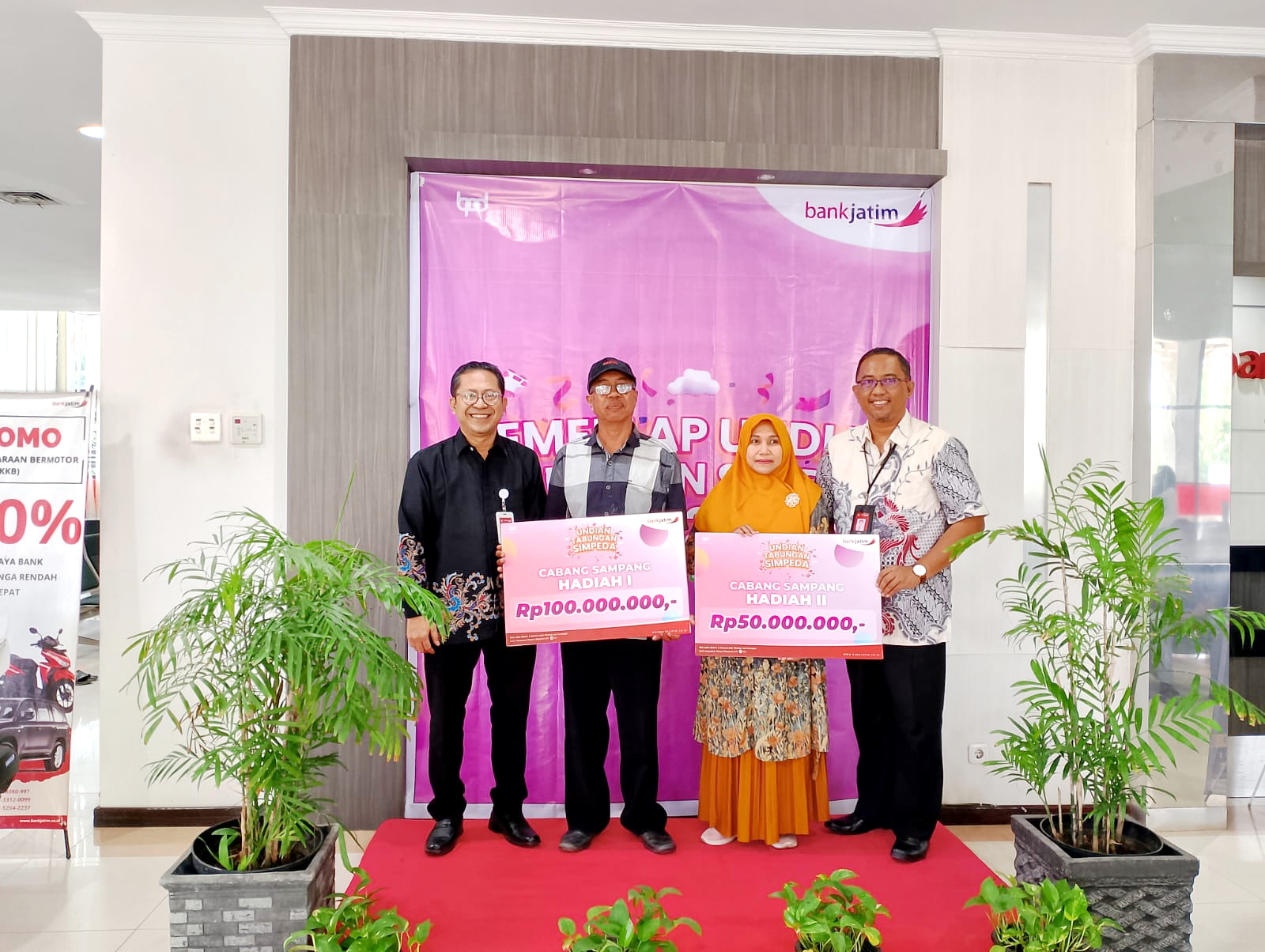 PEDULI: Pemimpin Cabang (Pimcab) Bank Jatim Sampang Didik Yanuardi (kiri) berfoto bersama dengan dua nasabah seusai memberikan hadiah di kantornya Kamis (28/11). (UBAIDILLAHIR RAIE/JPRM)