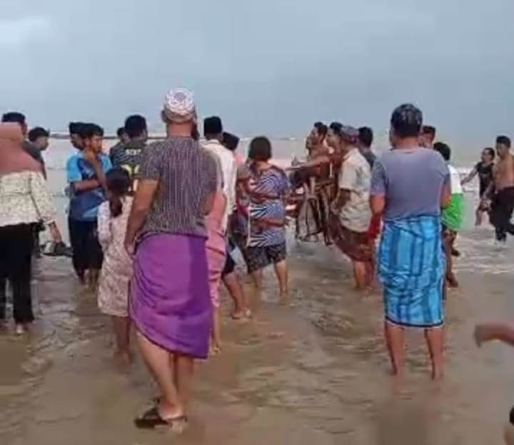 BERDUKA: Warga saat melakukan evakuasi terhadap korban tenggelam di Pantai Sokobanah, Sampang (8/12).
