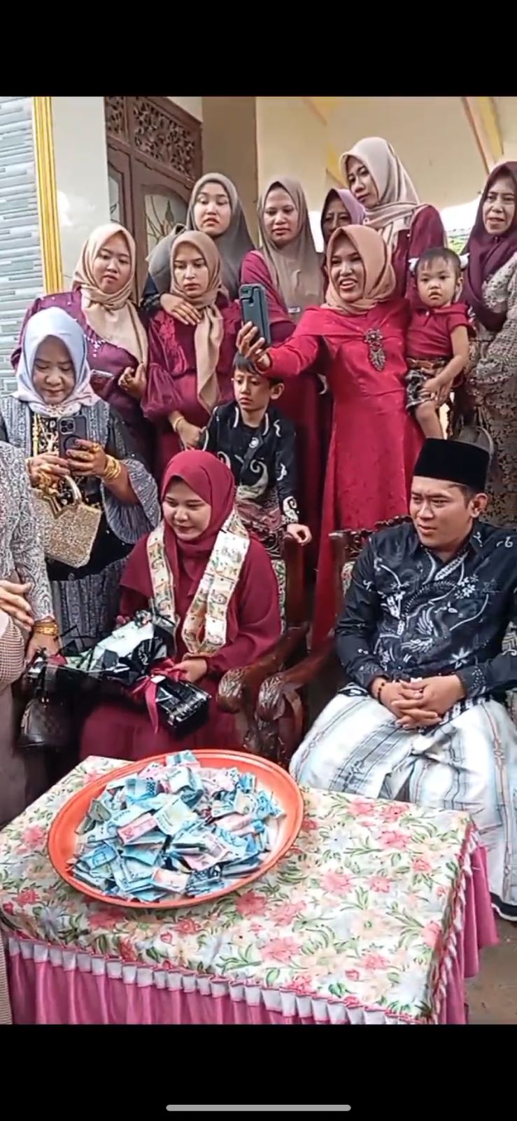 MERIAH: Warga menghitung uang hasil ontalan pertunangan di Desa Tamberu Agung, Kecamatan Batumarmar, Pamekasan, Minggu&nbsp;(15/12). (TANGKAP LAYAR)
