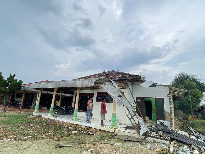 BUTUH PERBAIKAN: Asip melihat rumahnya yang rusak terkena angin puting beliung di Desa/Kecamatan Galis, Pamekasan, Selasa (23/12). (AYU LATIFAH/JPRM)