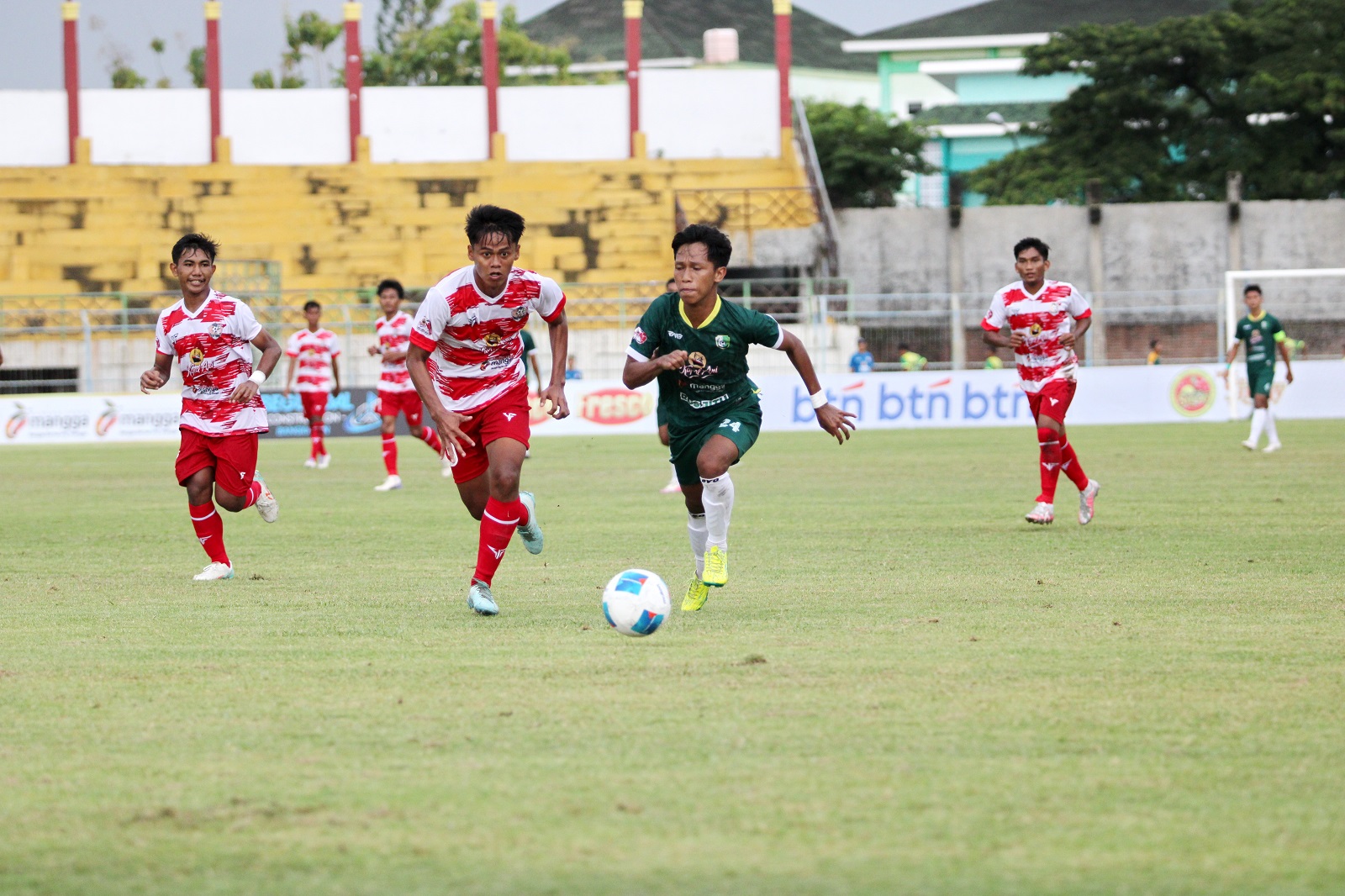 KENCANG: Pemain Persesa Sampang (hijau) membangun serangan ke lini pertahanan Persepam Pamekasan saat bertanding di SGB Minggu (5/1). (VIVIN AGUSTIN HARTONO/JPRM)