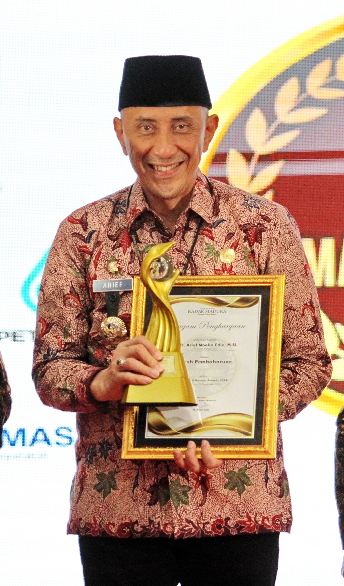 BUAH DARI PENGABDIAN: Pj Bupati Bangkalan Arief M. Edie menerima penghargaan Tokoh Pembaharuan di MA 2024 yang digelar di Gedung Sentra IKM, Jumat (20/12/2024).