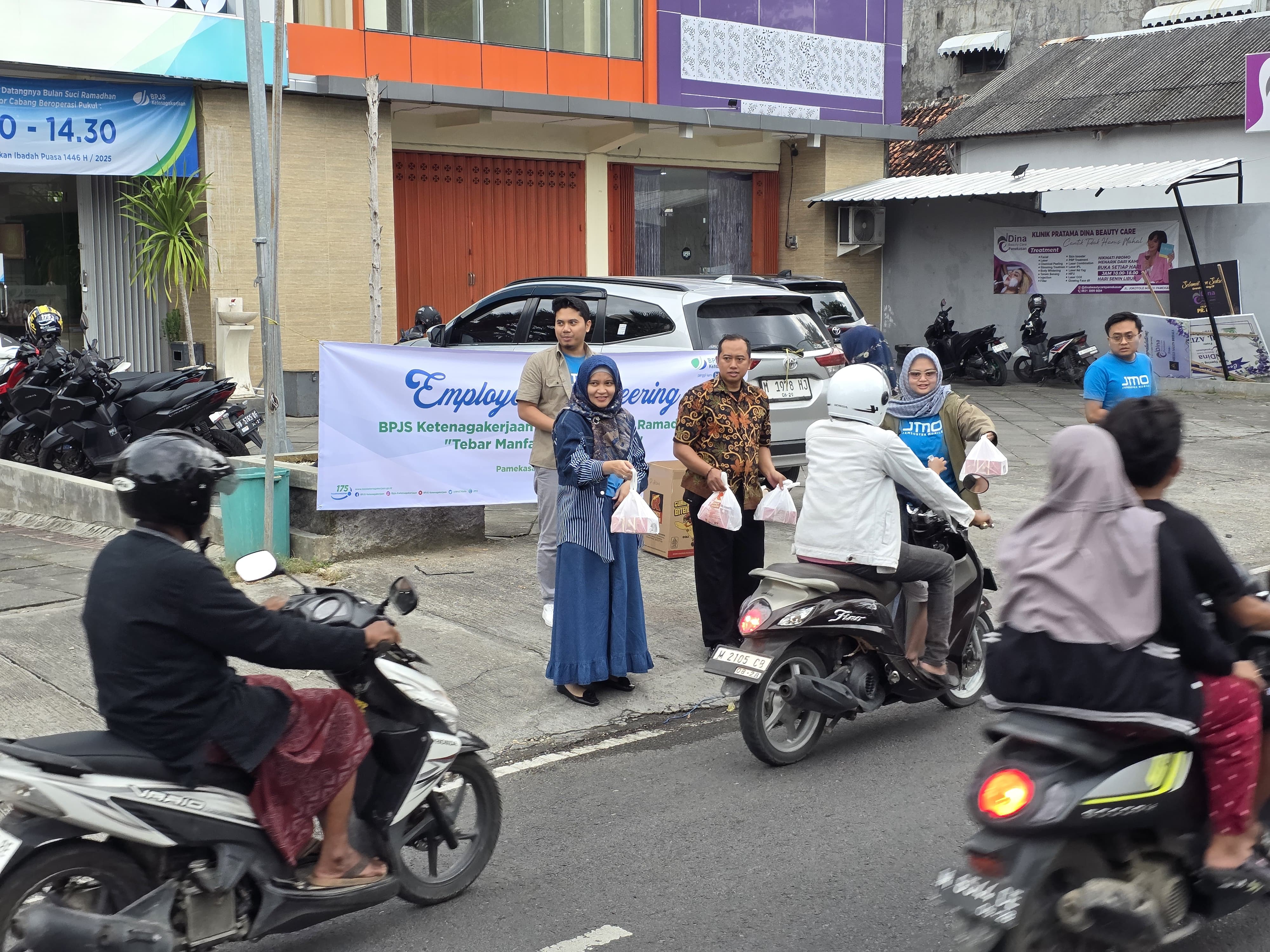 ANTUSIAS: Kepala BPJS Ketenagakerjaan Pamekasan Anita Ardhiana bersama karyawan berbagi takjil menjelang buka puasa di Jalan Jokotole, Pamekasan, Jumat (7/3). (BPJS KETENAGAKERJAAN PAMEKASAN)