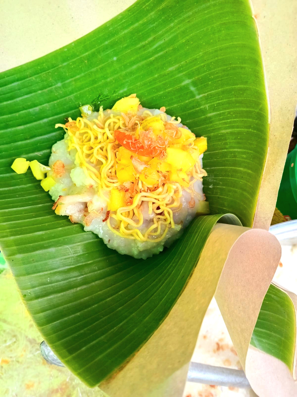 Penampakan tajin lemak dengan topping acar timun dan mi.