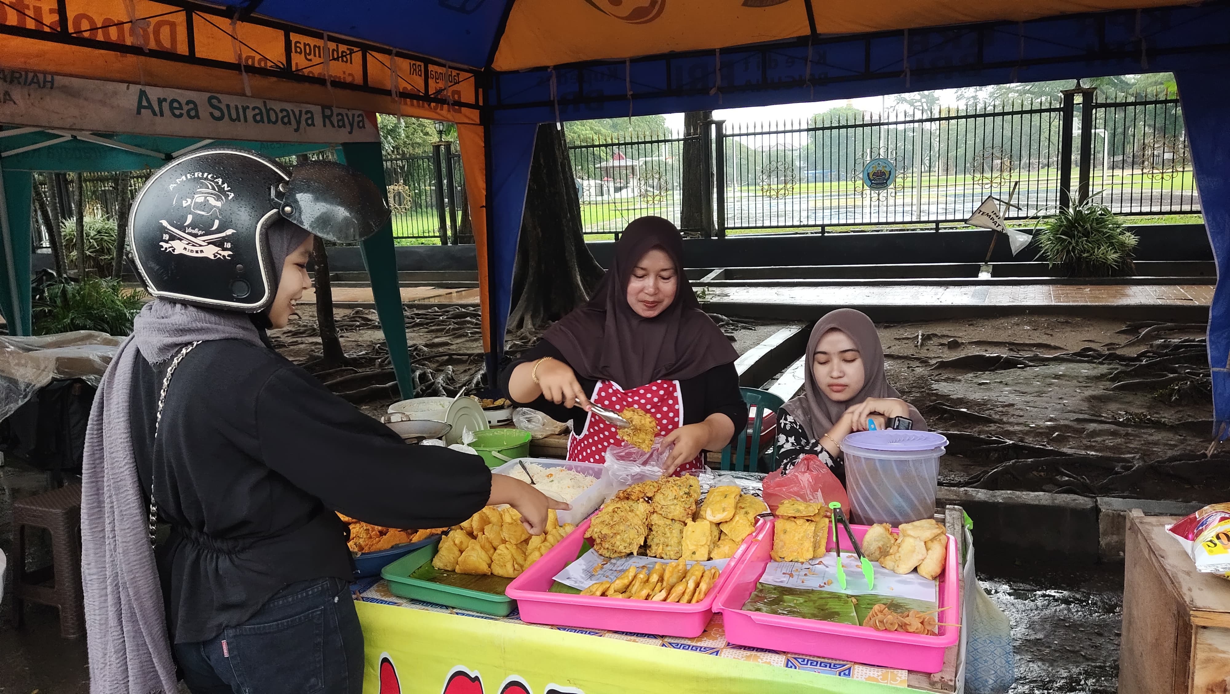 BANYAK DIMINATI: Maliyah tengah melayani pembeli di Bazar Takjil Ramadan kemarin. (ZEINAL ABIDIN/JPRM)