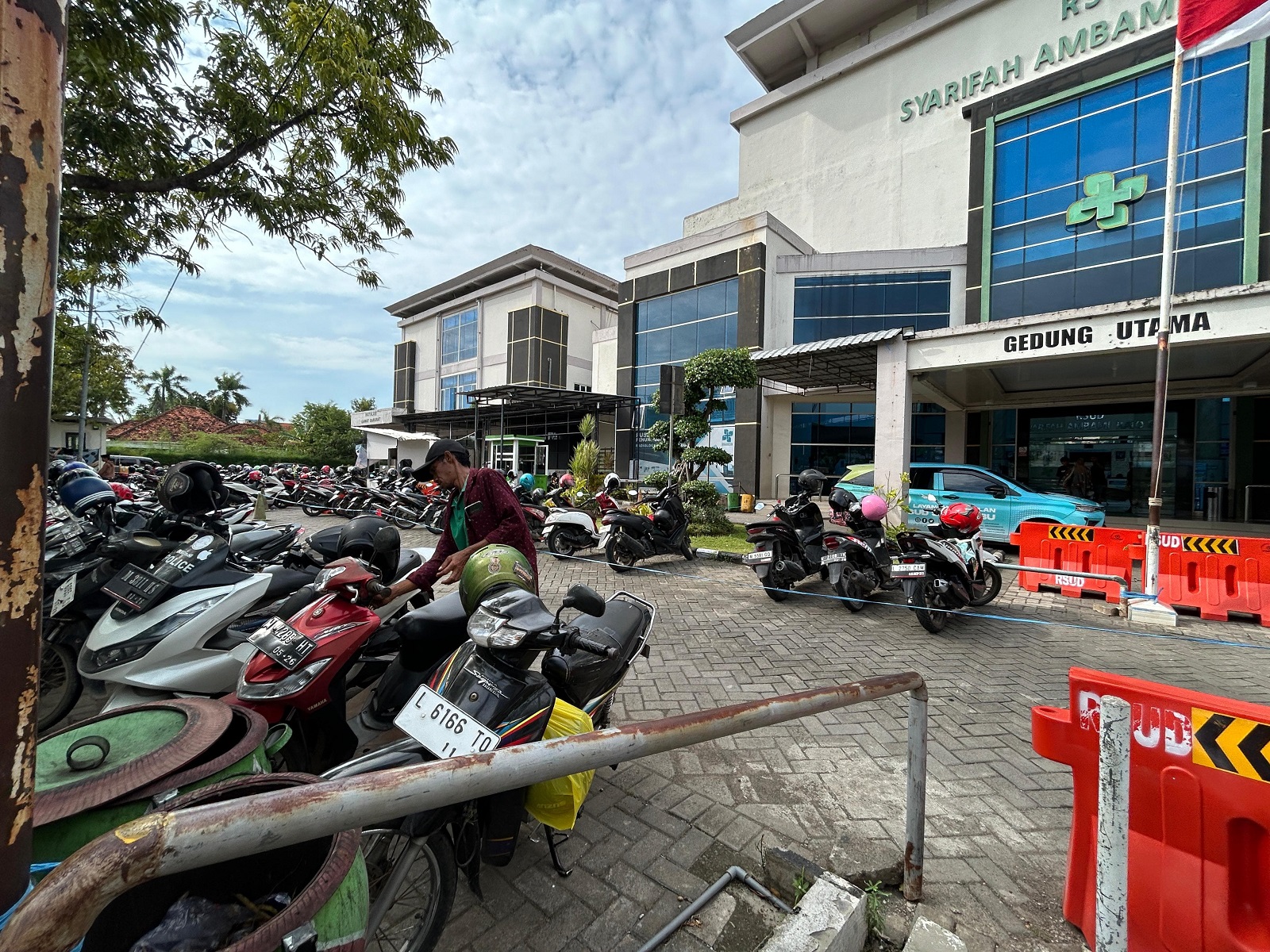 PEMBANGUNAN FASILITAS: Pengunjung RSUD Syamrabu mengambil kendaraannya di tempat parkir roda dua sementara Senin (24/3). (VIVIN AGUSTIN HARTONO/JPRM)