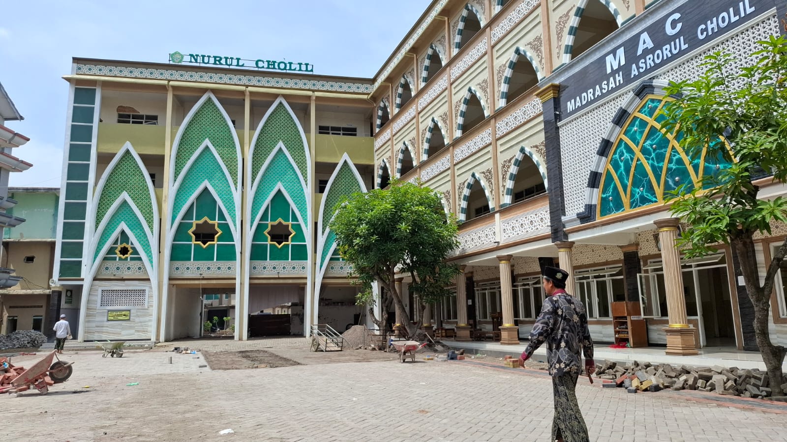 SANTAI: Sekretaris Ponpes Nurul Cholil Qusairi berjalan di halaman gedung MA Nurul Cholil Bangkalan, Jumat (7/2). (IMAMUDIN/JPRM)