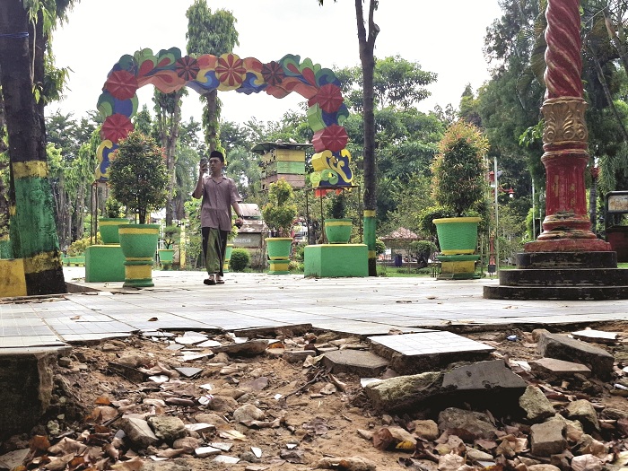 BUTUH PERBAIKAN: Warga bersantai di area Taman Bunga Pottre Koneng Sumenep Kamis (22/5). (MOH. LATIF/JPRM)