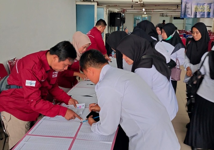 HITAM PUTIH: Peserta seleksi PPPK 2024 tahap dua Bangkalan mengisi daftar hadir sebelum mengikuti tes kompetensi di Grand Atrium Jawa Pos Surabaya, Selasa (13/5).