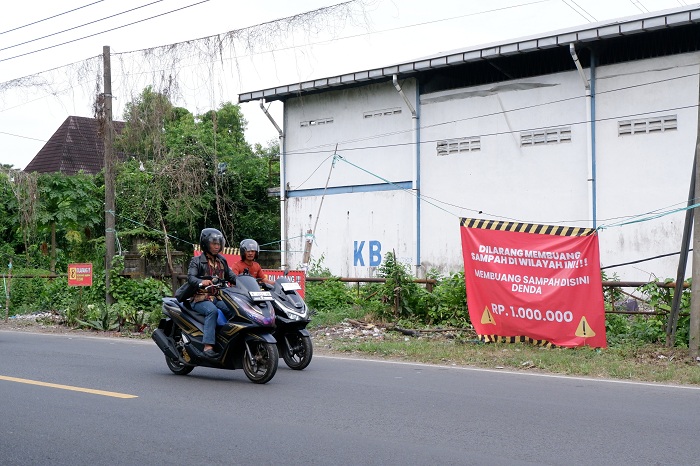 HARUS STERIL: Pengguna jalan melintas di kawasan yang tidak boleh dijadikan tempat pembuangan sampah di Jalan Raya Burneh, Bangkalan, Kamis (26/6). (VIVIN AGUSTIN HARTONO/JPRM)