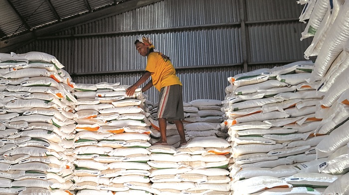 STOK BANTUAN: Pekerja menata beras bantuan di Gudang Bulog Bangkalan, Jumat (11/7). (M. KHOLIL RAMLI/JPRM)