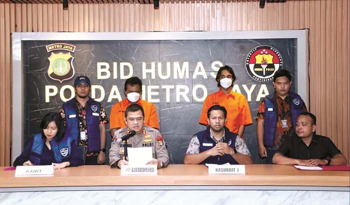 BERBAJU ORANYE: Suhartono (kiri) dan K Fagih saat dirilis oleh Polda Metro Jaya, Jumat (1/8). (INSTAGRAM DIREKTORAT RESERSE SIBER POLDA METRO JAYA)