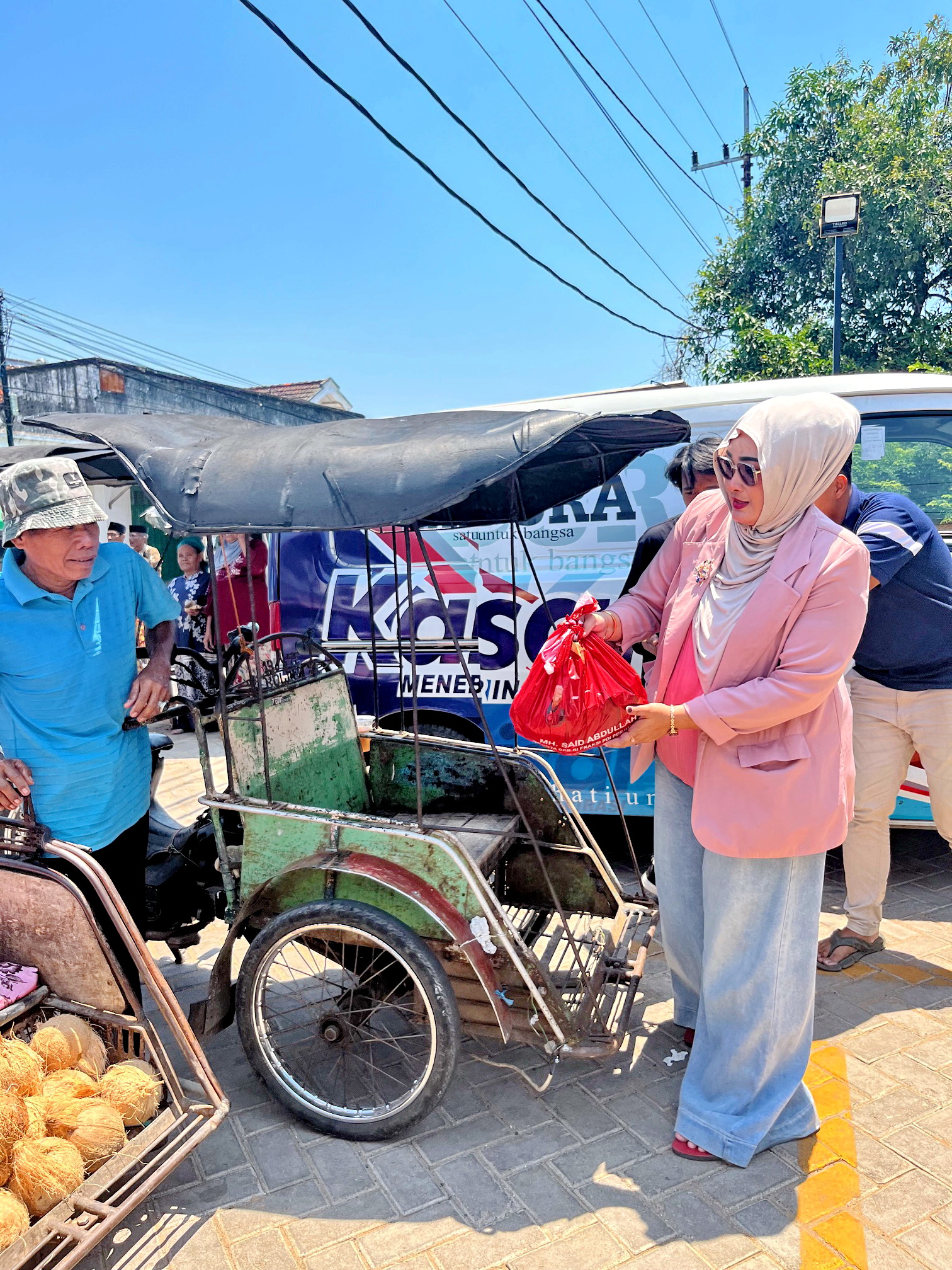 PEDULI: Tim Said Abdullah Institute menyerahkan paket sembako ke abang becak yang mangkal di depan Lapangan Karapan Sapi, Desa Pangarangan, Kecamatan Kota Sumenep, Selasa (23/9).
