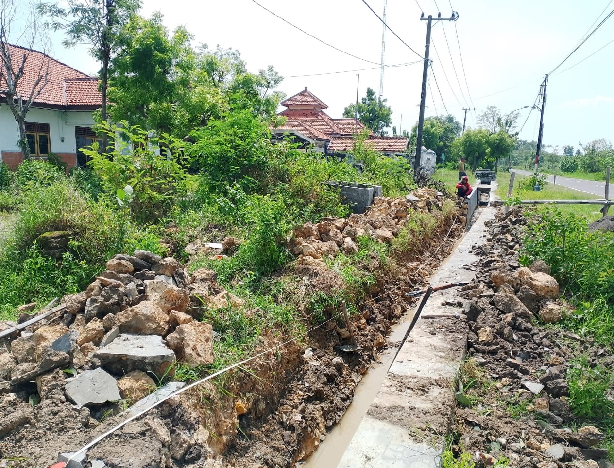 DIPERBAIKI: Tukang berada di area proyek BK pembangunan saluran di Desa Apaan, Kecamatan Pangarengan, yang ambruk 17 meter, Selasa (25/11).
