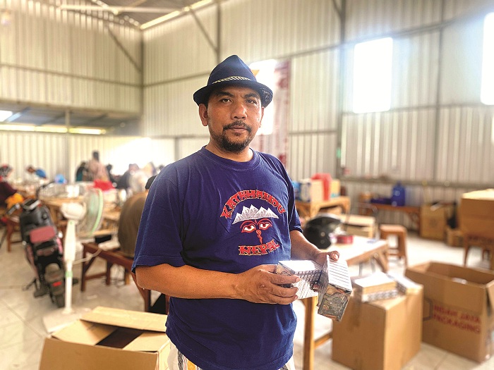 BEKERJA: Direktur CV Jawara Internasional Djaya Marsuto Alfianto berada di gudang miliknya di Kecamatan Palengaan, Pamekasan, Selasa (2/12). (MOH. IQBAL AFGANI/JPRM)