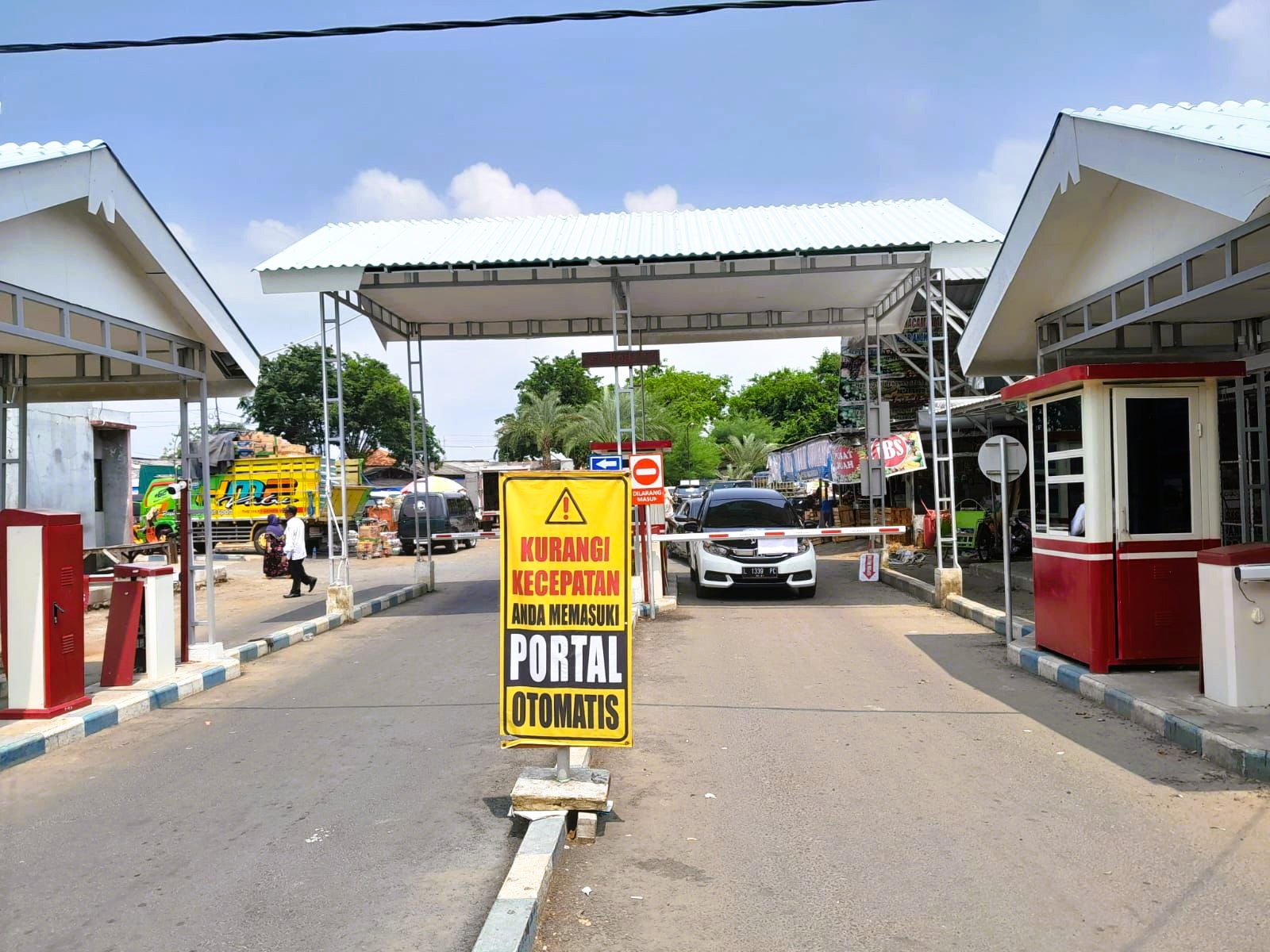 TERBATAS: Pengunjung melintasi portal di pintu masuk Pasar Anom Baru Sumenep di Desa Kolor Kecamatan Kota, Kamis (18/12).