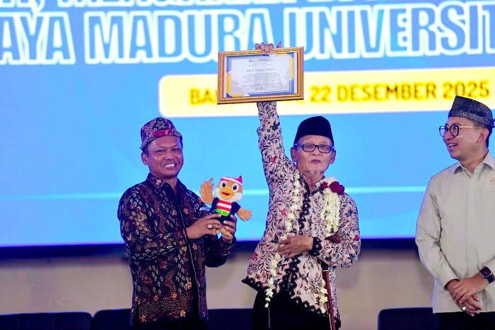 SEMRINGAH: Budayawan nasional KH D. Zawawi Imron mengangkat piagam penghargaan yang diberikan oleh Rektor UTM Prof Safi, Senin (22/12). (UTM UNTUK JPRM)