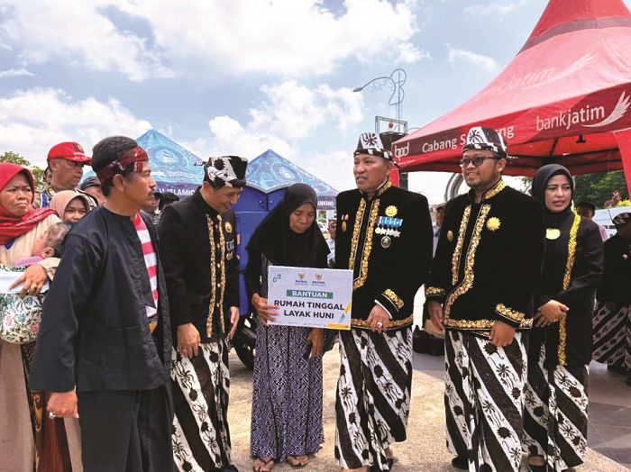 SIMBOLIS: Bupati Slamet Junaidi didampingi Wabup dan Sekkab bersama Kepala Baznas Sampang Abd. Rouf Al-Hitami menyerahkan bantuan RTLH kepada penerima manfaat di Alun-Alun Trunojoyo, Selasa (23/12).