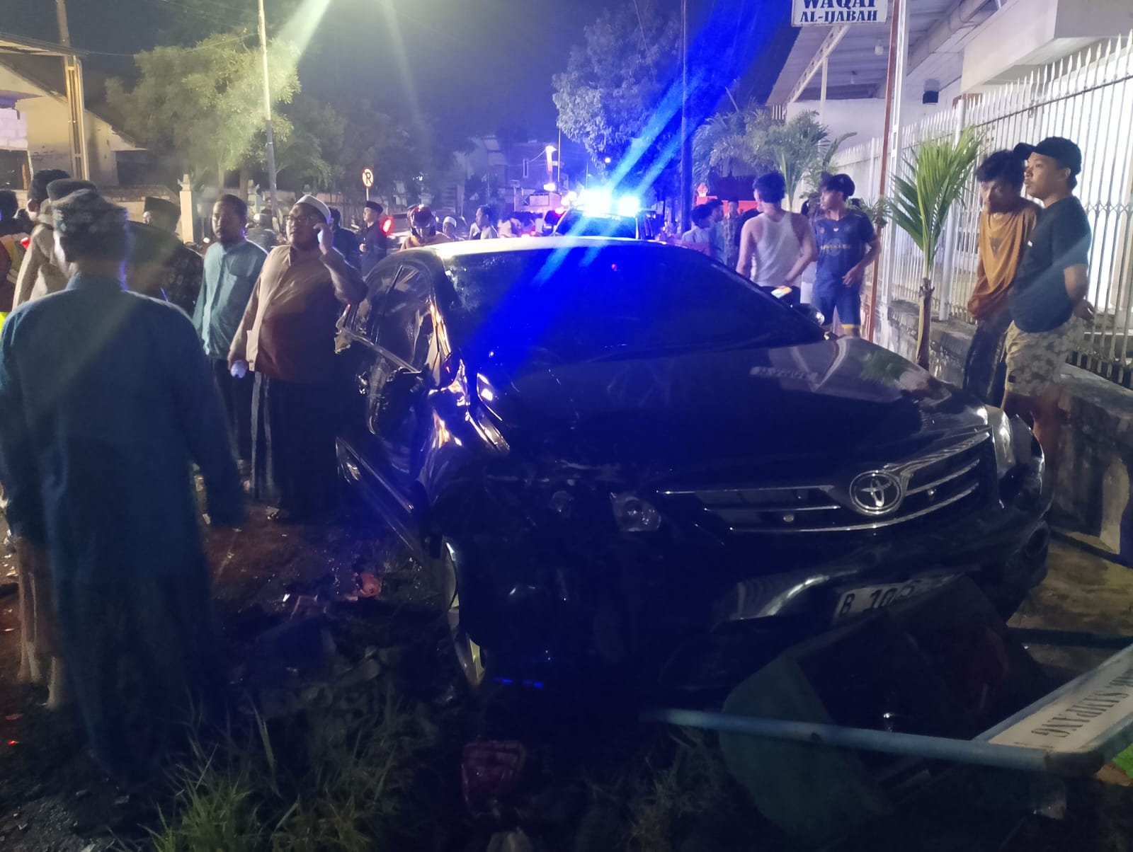 REMUK: Warga melihat kendaraan Toyota Corolla Altis yang terlibat laka di Jalan Imam Bonjol, Sampang, Senin (5/1) malam