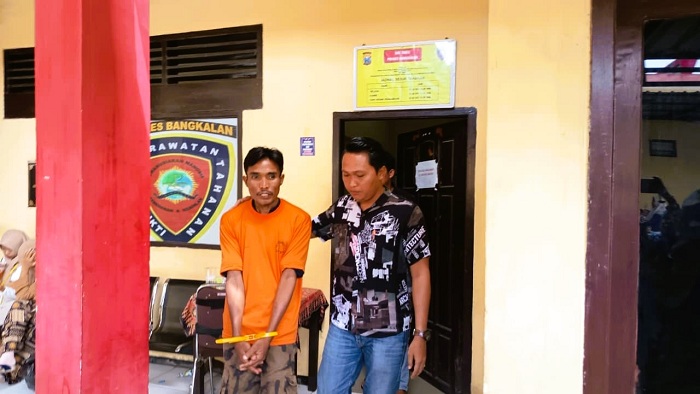 TERTUNDUK MALU: Tersangka kasus curanmor Moh. Nafi saat digiring polisi di Mapolres Bangkalan Kamis (8/1). (ZEINAL ABIDIN/JPRM)