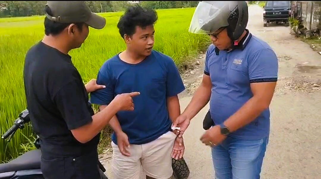 TAK BERKUTIK: Tersangka AR saat diperiksa polisi di tepi jalan Desa Komis, Kecamatan Kedungdung, Sampang, Kamis (15/1).