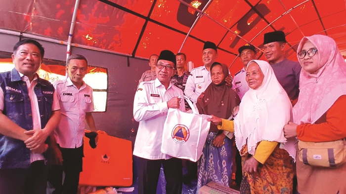 SIMBOLIS: Bupati Pamekasan KH Kholilurrahman dan Wabup Sukriyanto memberikan bantuan kepada korban bencana tanah bergerak di Desa Sana Daja, Kecamatan Pasean, Rabu (21/1). (M. KHOLIL RAMLI/JPRM)
