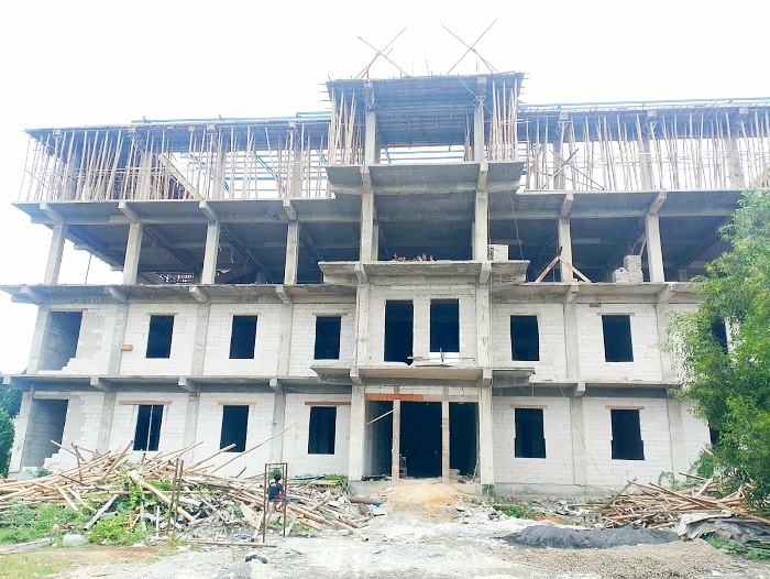 BELUM TUNTAS: Warga berada di sekitar pembangunan gedung IAI Nata Sampang Selasa (10/2). (UBAIDILLAHIR RAIE/JPRM)