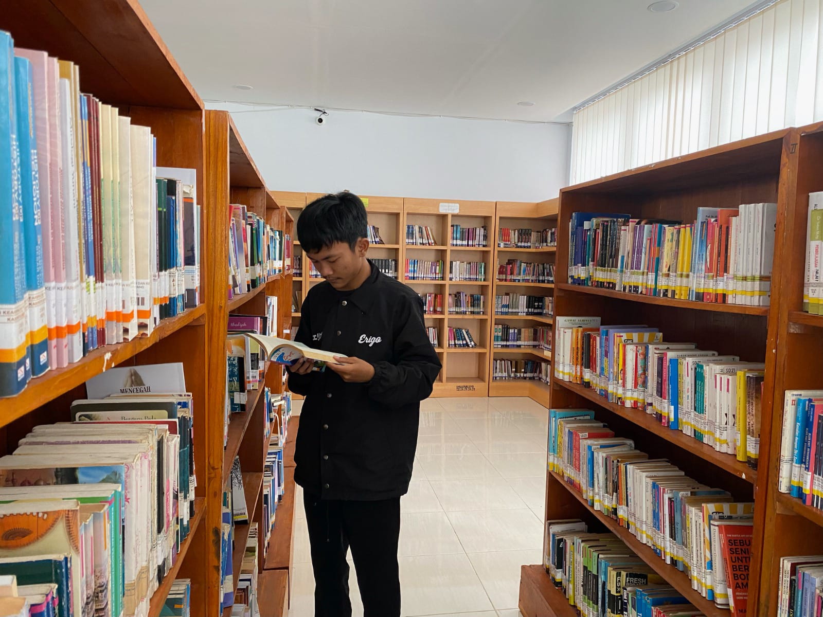 TINGKATKAN LITERASI: pengunjung sedang melihat koleksi buku di Perpusda Sampang beberapa waktu lalu.