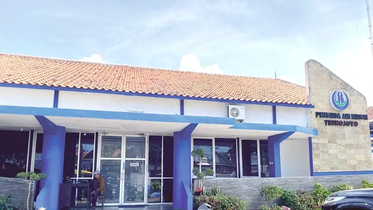 PELAYANAN: Petugas keamanan saat berjaga di depan kantor Perumdam Trunojoyo Sampang kemarin. (AYU LATIFAH/JPRM)