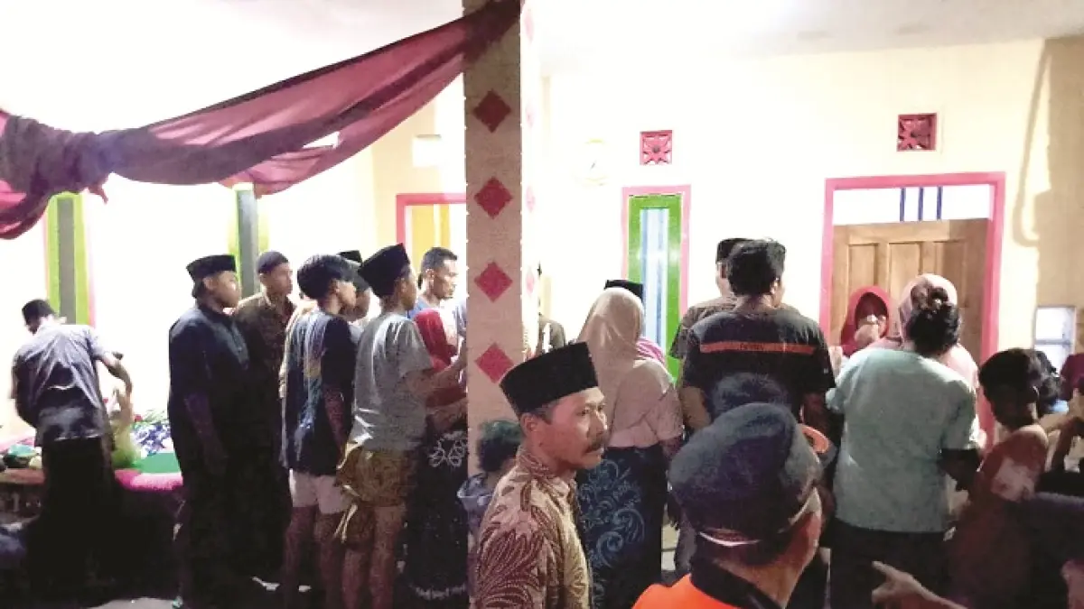 BERKABUNG: Warga dan aparat berada di rumah korban Jusuf P. Mahud di Desa Lajing, Kecamatan Arosbaya, Bangkalan, Selasa (14/4). (BPBD BANGKALAN UNTUK JPRM)
