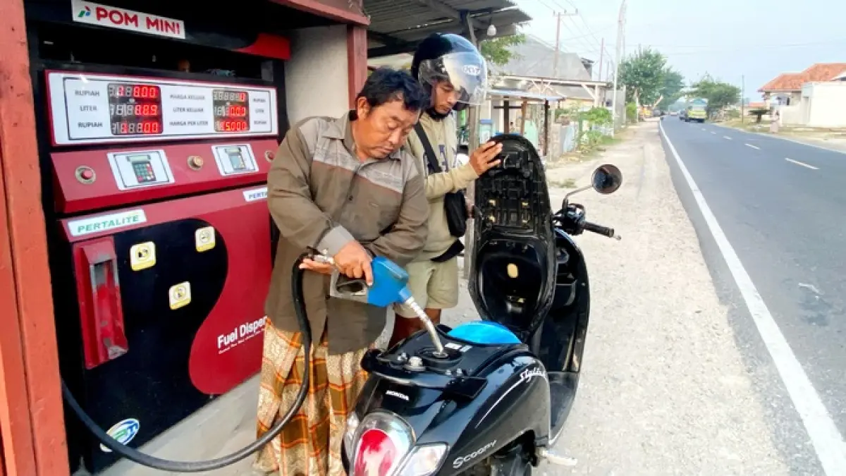 BAHAN BAKAR: Pengecer saat mengisi bahan bakar di Jalan Raya Camplong, Sampang, Minggu (19/4). (AYU LATIFAH/JPRM)