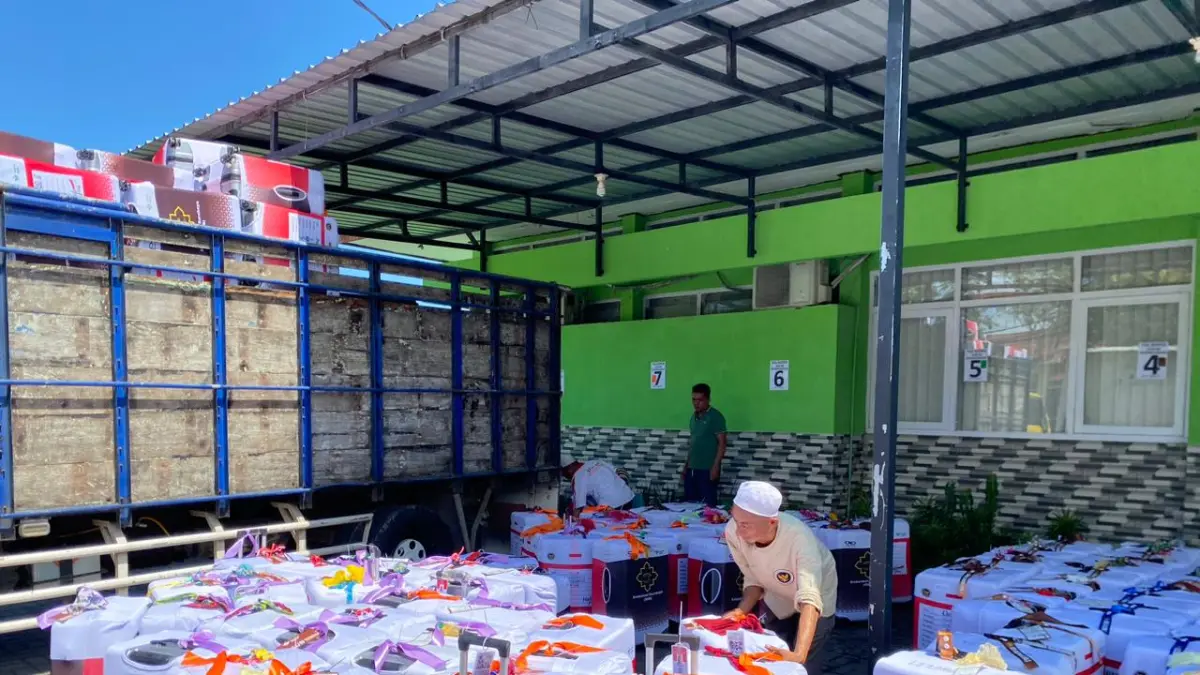 PERSIAPAN: Petugas saat menaikkan koper ke truk di halaman Kemenag Sampang Jumat (8/5).