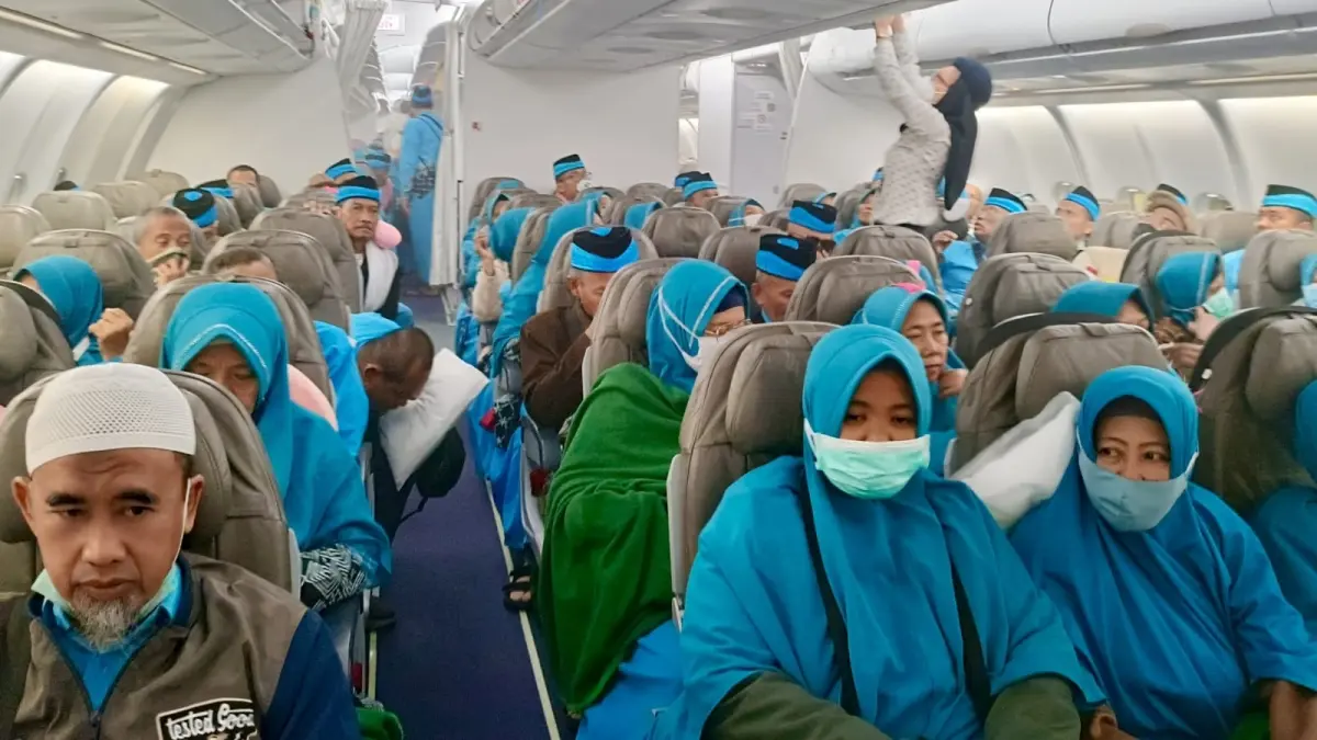 MENUJU TANAH AIR: Sejumlah jemaah saat berada dalam pesawat saat penerbangan dari Madinah menuju Bandara Juanda, Sabtu (20/6).