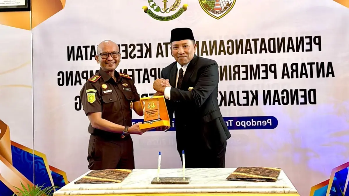 SIMBOLIS: Bupati Slamet Junaidi menerima cenderamata dari Kajari Sampang Mochamad Iqbal di Peringgitan Pendopo Trunojoyo Sampang, Senin (22/6). (UBAIDILLAH UNTUK JPRM)